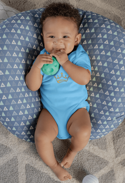 mockup of a sweet baby boy with a onesie lying on a big pillow 25119 1 AFROCENTRIC EMBROIDERY DESIGNS EMBROIDERY,AFROCENTRIC