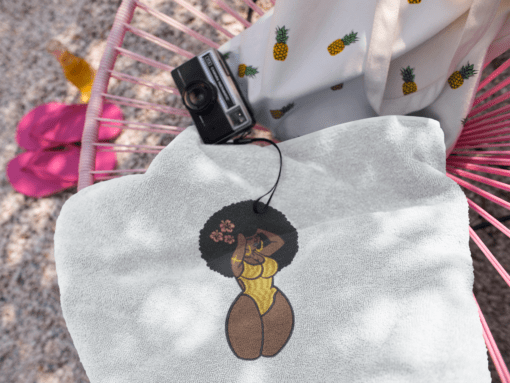 towel on a pink acapulco chair with a vintage camera and a bag near it a14896 AFROCENTRIC EMBROIDERY DESIGNS curves