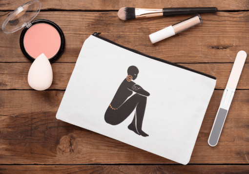 mockup of a cosmetic pouch lying on a wooden surface 29991 1 AFROCENTRIC EMBROIDERY DESIGNS GODDESS