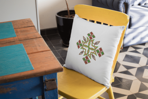mockup of a square pillow placed on a yellow chair 23561 AFROCENTRIC EMBROIDERY DESIGNS ethiopian